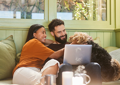 couple online banking with their dog